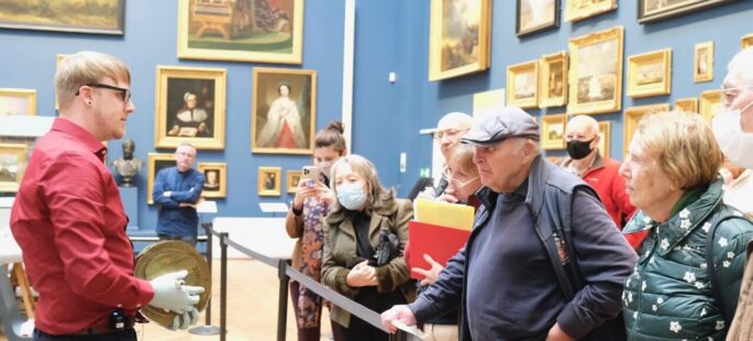 A group of people in a gallery exhibition