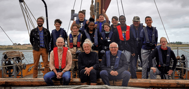 Group of people together on a ship